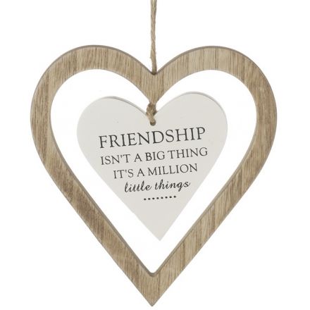 Heart-shaped wooden plaque with a white center and text, hanging against a white background.