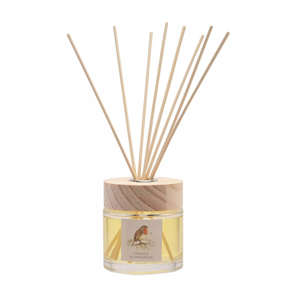 Cylindrical glass jar with square label on the front featuring watercolour robin illustation. Glass jar covered with wooden top and a hole for the reed diffusers to come out. 