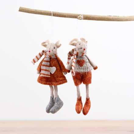 Two plush mouse toys in autumn-themed clothing hanging on a stick against a white background.