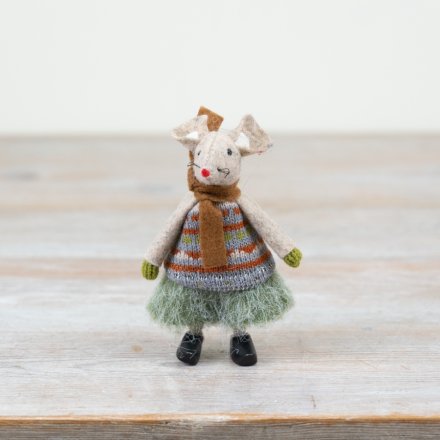 Knitted mouse figurine wearing a sweater and skirt on a wooden surface