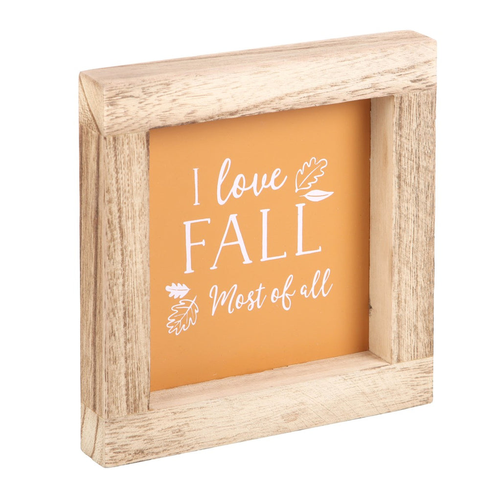 Wooden-framed sign with 'I love Fall Most of all' text on an orange background