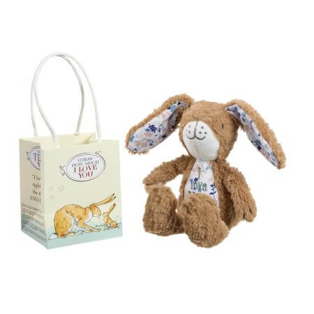 Plush bunny toy with floral ears and a gift bag on a white background