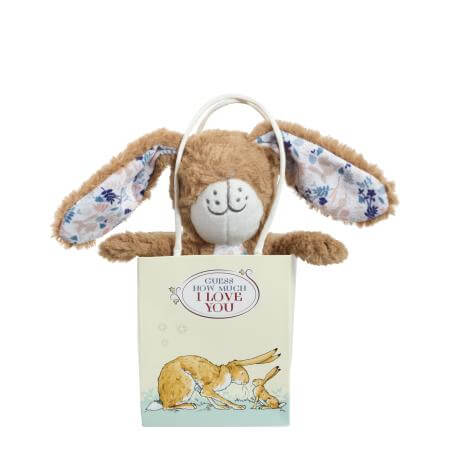 Plush bunny with floral ears on a gift bag with text and illustrations.
