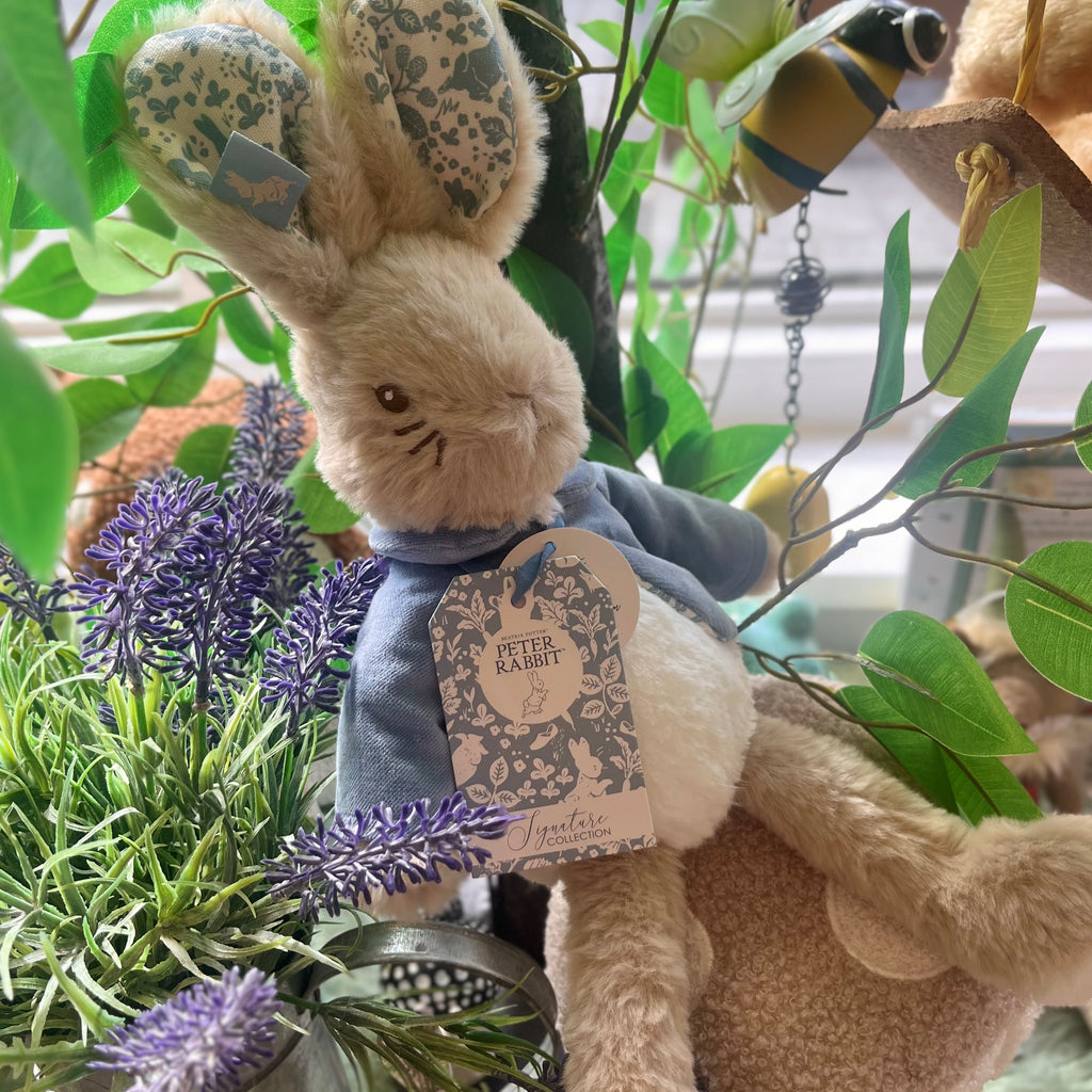 Fluffy Peter Rabbit soft toy with floral patterned ears and a blue coat with embroidered face details. 