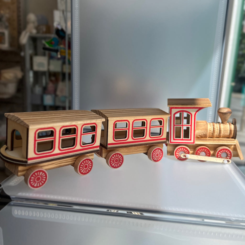 Wooden toy train set with red detailing
