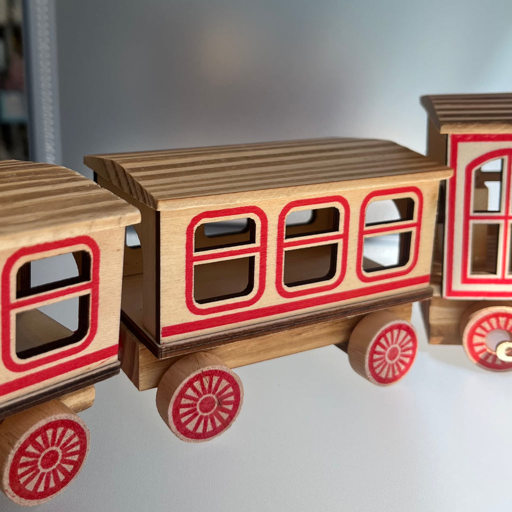 Wooden toy train with red accents 