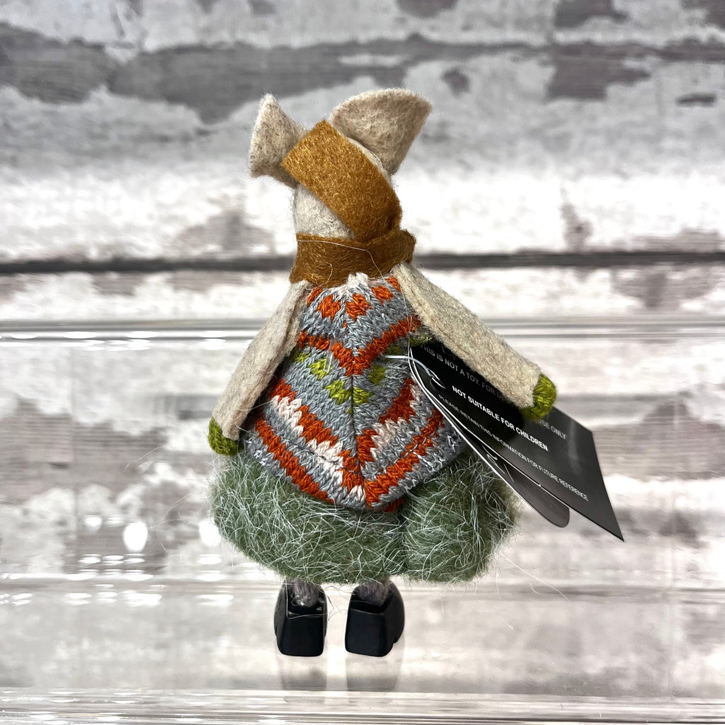 Back side of fabric mouse decoration on a wooden background 