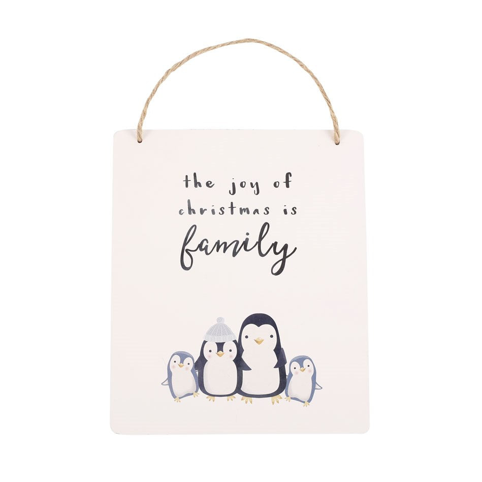 Decorative sign with family of penguins penguins and 'the joy of Christmas is family' text on a white background