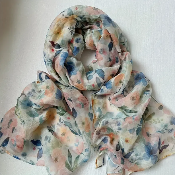 Multicolour floral scarf with pinks, oranges, greens, and blue colours.