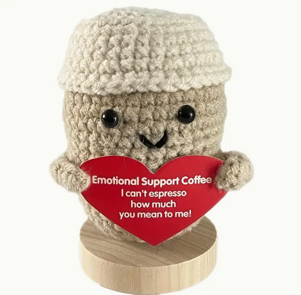 Knitted wool brown takeaway coffee cup with lid and a smiley face. Holding a red card heart with the text 'emotional support coffee' I can't espresso how much you mean to me. 