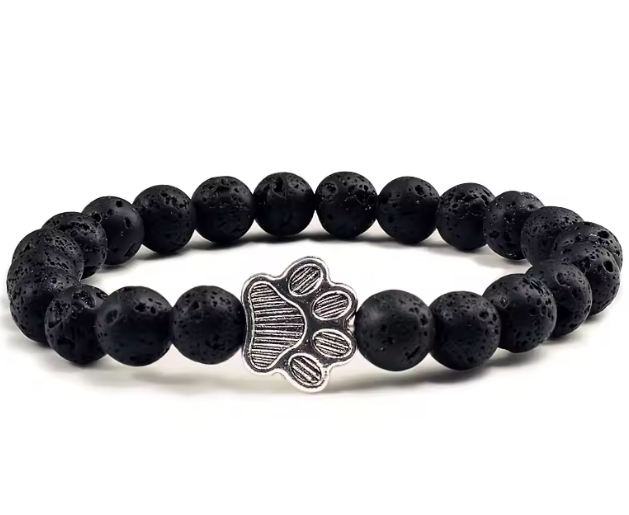 Black beaded bracelet with a paw print charm on a white background