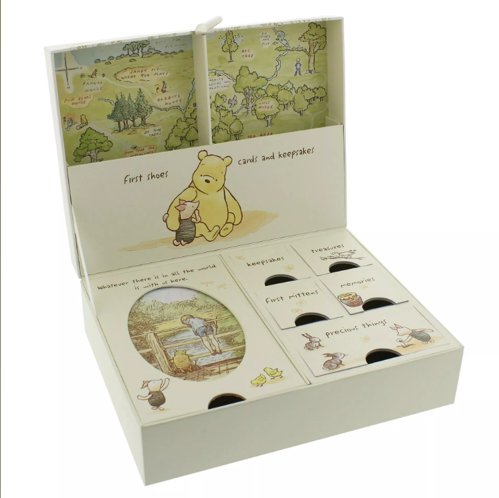 Colorful hundred acre wood map on the background of the lid. 8 compartments with 'first shoes' and 'cards and keepsakes' at the top in the lid and the rest of the compartments in the bottom of the boc with one large comparment taking up one half side. 