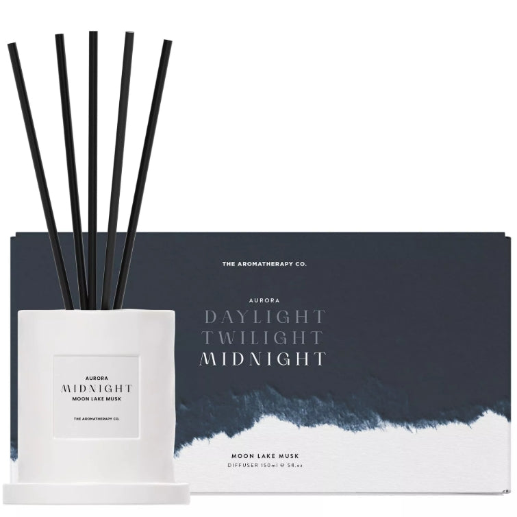 Diffuser set with black sticks and white container labeled 'Aurora Midnight' by The Aromatherapy Co.