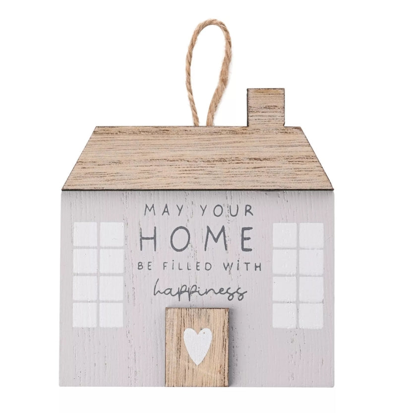 Decorative wooden house-shaped sign with text on a white background
