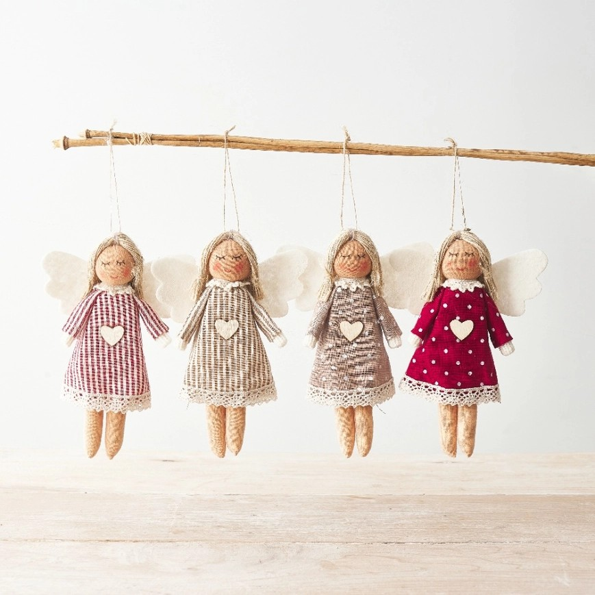 Hanging angels in four designs, made from fabric. All feature a sleeping/smiling face, a small wooden heart on their stomach, and white angel wings. One angel is in a red dress with white polka dots, one is in a  dress with red and white stripes, one is in a beige dress with white polka dots, and the last one is in a dress with beige and white stripes. 