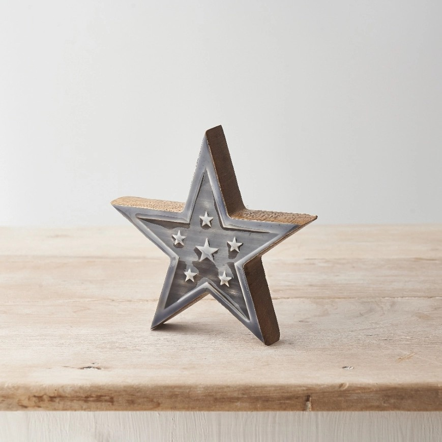 Wooden star with grey glaze on the front with six more stars.